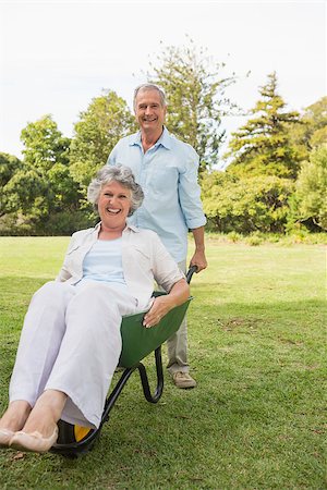 deckchair senior man - Funny man pushing his wife in a wheelbarrow outside in the sunshine Stock Photo - Budget Royalty-Free & Subscription, Code: 400-06934205