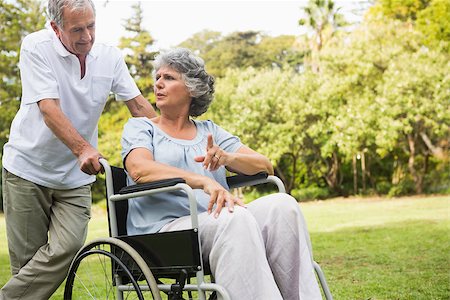 deckchair senior man - Mature woman in wheelchair speaking with partner in the park on sunny day Stock Photo - Budget Royalty-Free & Subscription, Code: 400-06934211