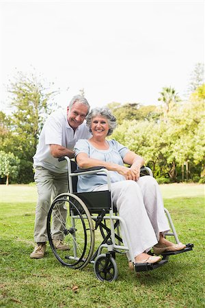 deckchair senior man - Happy mature woman in wheelchair with partner looking at camera in the park Stock Photo - Budget Royalty-Free & Subscription, Code: 400-06934213