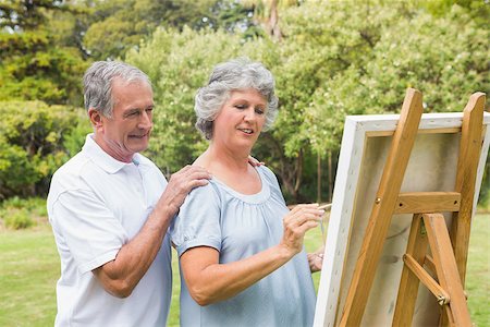Peaceful retired woman painting on canvas with husband in the park Stock Photo - Budget Royalty-Free & Subscription, Code: 400-06934229