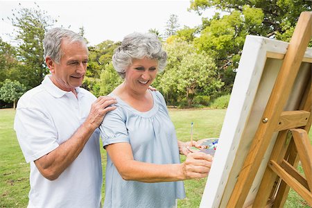 Content retired woman painting on canvas and talking with husband in the park on sunny day Stock Photo - Budget Royalty-Free & Subscription, Code: 400-06934236