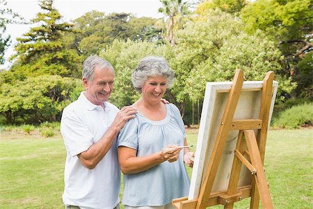 Cheerful retired woman painting on canvas with husband in the park on sunny day Stock Photo - Budget Royalty-Free & Subscription, Code: 400-06934231