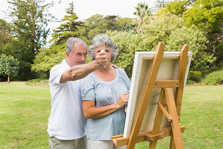 Content retired woman painting on canvas with husband who is measuring something with brush Stock Photo - Budget Royalty-Free & Subscription, Code: 400-06934232