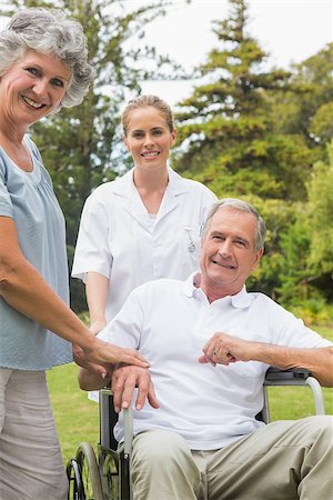 simsearch:6109-06684838,k - Happy man in a wheelchair with his nurse and wife smiling at camera in the park Foto de stock - Super Valor sin royalties y Suscripción, Código: 400-06934247