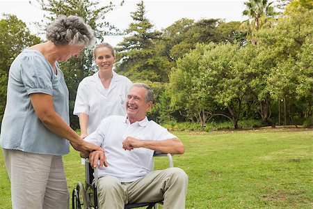 simsearch:6109-06684838,k - Happy man in a wheelchair laughing with his nurse and wife on sunny day in park Foto de stock - Super Valor sin royalties y Suscripción, Código: 400-06934249