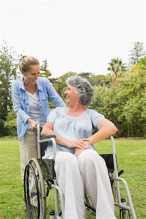 simsearch:6109-06684838,k - Happy mature woman in wheelchair talking with daughter in the park on sunny day Foto de stock - Super Valor sin royalties y Suscripción, Código: 400-06934255