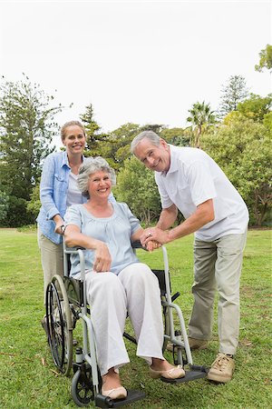 simsearch:6109-06684838,k - Woman sitting in wheelchair her husband holding her hands and daughter smiling at camera Foto de stock - Super Valor sin royalties y Suscripción, Código: 400-06934259