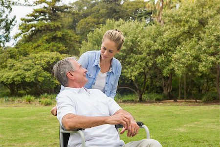 simsearch:6109-06684830,k - Man in wheelchair and daughter talking in park on sunny day Stock Photo - Budget Royalty-Free & Subscription, Code: 400-06934250