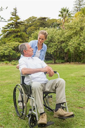 simsearch:6109-06684830,k - Happy man in wheelchair and daughter talking on sunny day in park Stock Photo - Budget Royalty-Free & Subscription, Code: 400-06934251