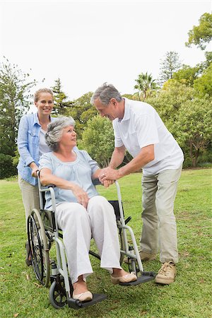 simsearch:6109-06684830,k - Mature woman in wheelchair with husband and daughter talking in park Stock Photo - Budget Royalty-Free & Subscription, Code: 400-06934260