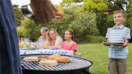 Little boy waiting for barbecue cooked by father standing and holding his plate Foto de stock - Super Valor sin royalties y Suscripción, Código: 400-06934308