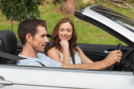 simsearch:400-07058112,k - Young couple driving in a silver convertible through the countryside in sunshine Photographie de stock - Aubaine LD & Abonnement, Code: 400-06934347