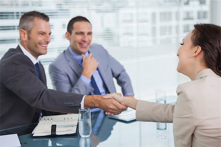 Cheerful young woman shaking hands with her future employer in bright office Stock Photo - Budget Royalty-Free & Subscription, Code: 400-06934680