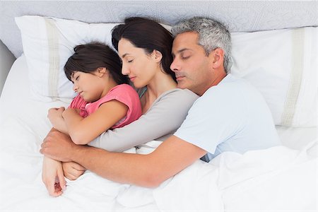 simsearch:400-06930138,k - Parents sleeping with their daughter in bed at home Stock Photo - Budget Royalty-Free & Subscription, Code: 400-06930072