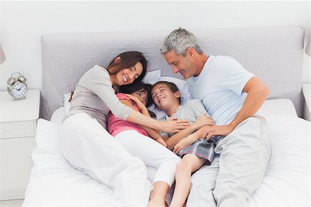 simsearch:400-06930138,k - Happy family lying on bed at home Stock Photo - Budget Royalty-Free & Subscription, Code: 400-06930080