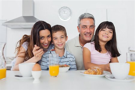 simsearch:400-06930138,k - Beautiful family eating breakfast in kitchen together at home Stock Photo - Budget Royalty-Free & Subscription, Code: 400-06930127