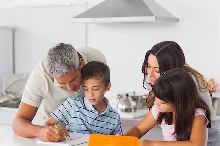 simsearch:400-06930138,k - Family drawing together in kitchen at home Stock Photo - Budget Royalty-Free & Subscription, Code: 400-06930134