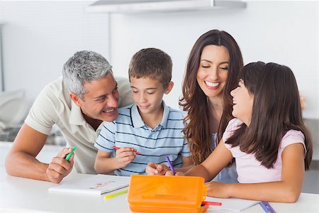 simsearch:400-06930138,k - Smiling family drawing together in kitchen at home Stock Photo - Budget Royalty-Free & Subscription, Code: 400-06930135