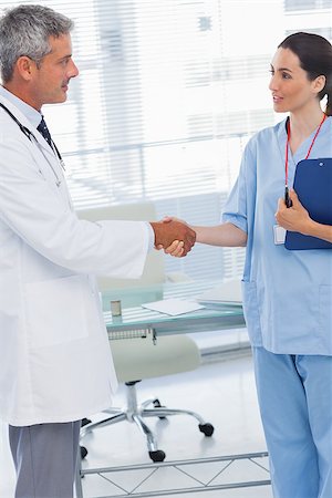 pictures of two nurses shaking hands - Doctor shaking hands with nurse in medical office Stock Photo - Budget Royalty-Free & Subscription, Code: 400-06930505