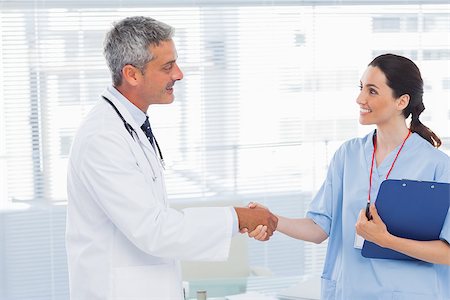 pictures of two nurses shaking hands - Smiling doctor shaking hands with nurse in medical office Stock Photo - Budget Royalty-Free & Subscription, Code: 400-06930506