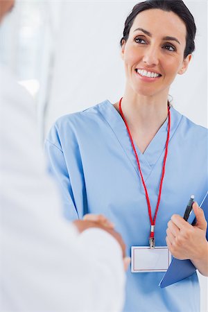 pictures of two nurses shaking hands - Happy nurse shaking hands with doctor in medical office Stock Photo - Budget Royalty-Free & Subscription, Code: 400-06930508