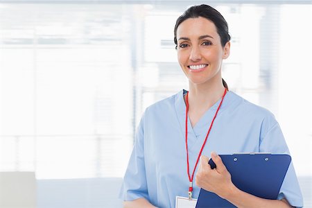 side images of dark hair nurse in uniform - Nurse holding files in medical office Stock Photo - Budget Royalty-Free & Subscription, Code: 400-06930500