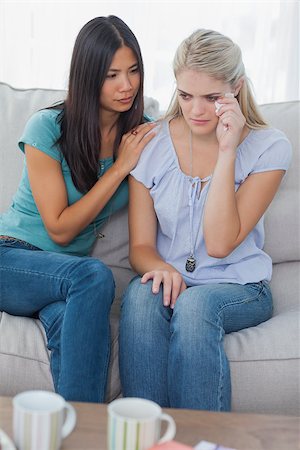 simsearch:400-07059986,k - Friend comforting her crying friend at home on the couch Stock Photo - Budget Royalty-Free & Subscription, Code: 400-06930764