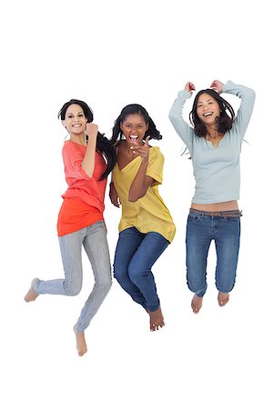 Diverse young women jumping and looking at camera on white background Stock Photo - Budget Royalty-Free & Subscription, Code: 400-06931029