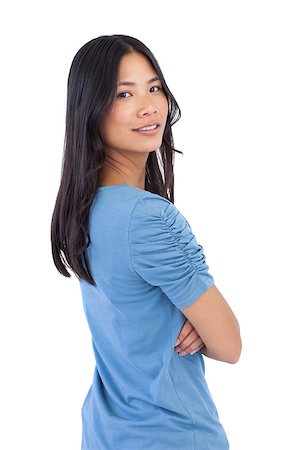 Smiling asian woman with arms crossed looking over her shoulder on white background Stock Photo - Budget Royalty-Free & Subscription, Code: 400-06931042