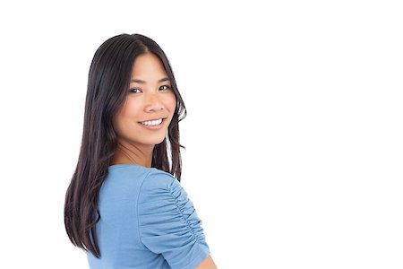Smiling asian woman looking over her shoulder on white background Stock Photo - Budget Royalty-Free & Subscription, Code: 400-06931043