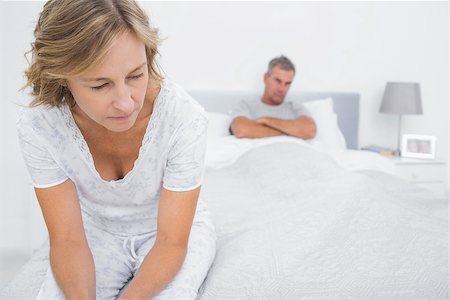 Couple sitting on opposite ends of bed after a fight at home in bedroom Stock Photo - Budget Royalty-Free & Subscription, Code: 400-06931286