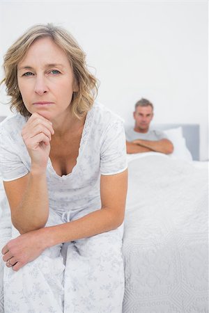 simsearch:400-06891126,k - Annoyed woman looking at camera after fight with husband in bedroom at home Stock Photo - Budget Royalty-Free & Subscription, Code: 400-06931290