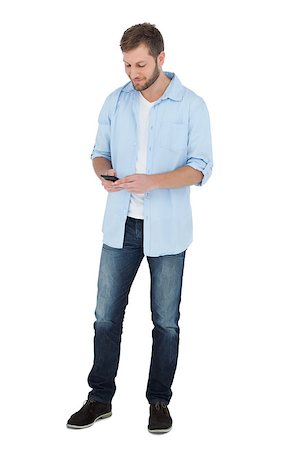 Relaxed model looking at his phone on white background Stock Photo - Budget Royalty-Free & Subscription, Code: 400-06931694