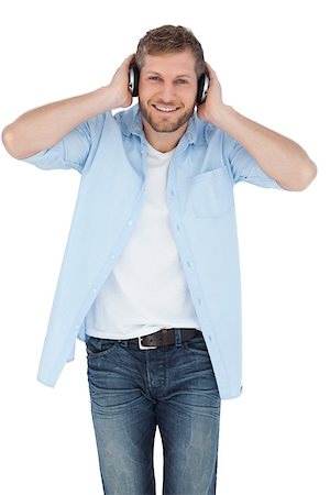 simsearch:400-06690896,k - Trendy model on white background listening to music and looking at camera Stock Photo - Budget Royalty-Free & Subscription, Code: 400-06931726