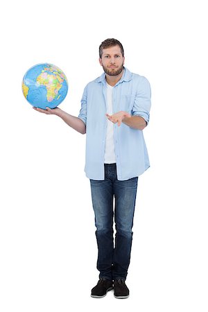 someone shrugging their shoulders - Charming model on white background holding a globe and shrugging shoulders Stock Photo - Budget Royalty-Free & Subscription, Code: 400-06931734