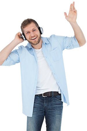 simsearch:400-06690896,k - Cool trendy model on white background listening to music and smiling Stock Photo - Budget Royalty-Free & Subscription, Code: 400-06931730