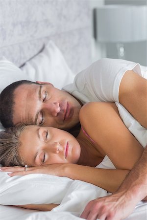 Cute couple sleeping and spooning in bed at home in bedroom Stock Photo - Budget Royalty-Free & Subscription, Code: 400-06931836