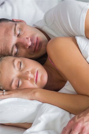 Attractive couple sleeping and spooning in bed at home in bedroom Stock Photo - Budget Royalty-Free & Subscription, Code: 400-06931837