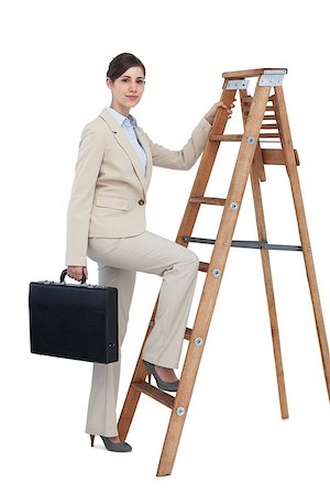 escalando los niveles empresariales - Businesswoman on white background climbing career ladder with briefcase and looking at camera Foto de stock - Super Valor sin royalties y Suscripción, Código: 400-06931996