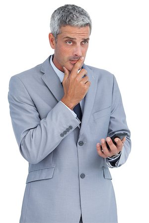 simsearch:400-07141016,k - Worried businessman holding his cellphone against white background Stockbilder - Microstock & Abonnement, Bildnummer: 400-06932167