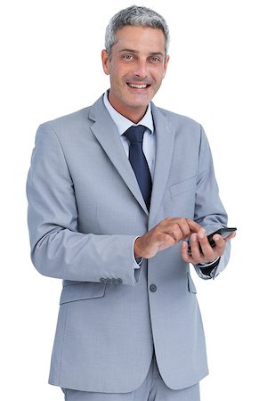 simsearch:400-07141016,k - Cheerful businessman sending text message looking at camera against white background and looking at camera Stockbilder - Microstock & Abonnement, Bildnummer: 400-06932163