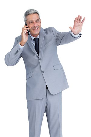 simsearch:400-07139155,k - Businessman against white background answering phone and waving Stock Photo - Budget Royalty-Free & Subscription, Code: 400-06932172