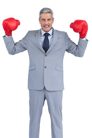 simsearch:649-05658209,k - Businessman posing with red boxing gloves on white background Stock Photo - Budget Royalty-Free & Subscription, Code: 400-06932185