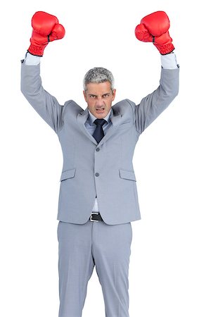 simsearch:649-05658209,k - Furious businessman posing with red boxing gloves on white background Stock Photo - Budget Royalty-Free & Subscription, Code: 400-06932188