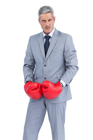 simsearch:649-05658209,k - Furious businessman posing with boxing gloves on white background Stock Photo - Budget Royalty-Free & Subscription, Code: 400-06932189