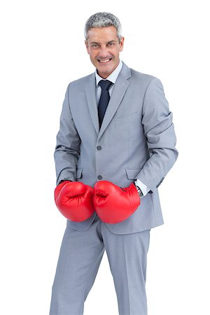 simsearch:649-05658209,k - Cool businessman posing with boxing gloves on white background Stock Photo - Budget Royalty-Free & Subscription, Code: 400-06932190