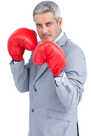simsearch:649-05658209,k - Tough businessman with boxing gloves on white background Stock Photo - Budget Royalty-Free & Subscription, Code: 400-06932191