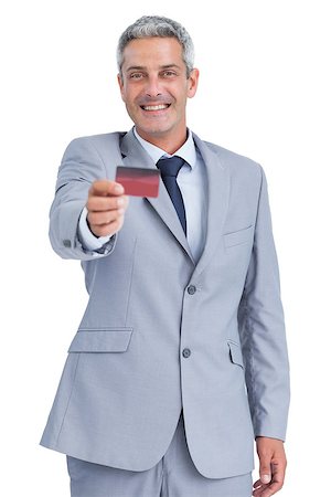 Handsome businessman on white background holding credit card Stock Photo - Budget Royalty-Free & Subscription, Code: 400-06932224