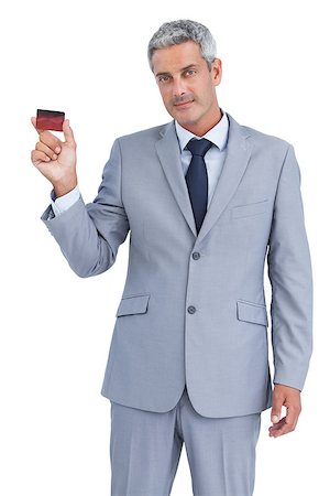 Handsome businessman on white background showing credit card Stock Photo - Budget Royalty-Free & Subscription, Code: 400-06932226