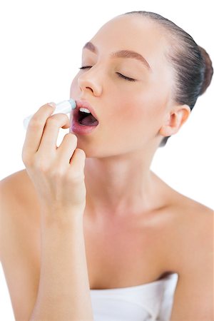 Sensual model putting lip balm on and closing eyes Stock Photo - Budget Royalty-Free & Subscription, Code: 400-06932353